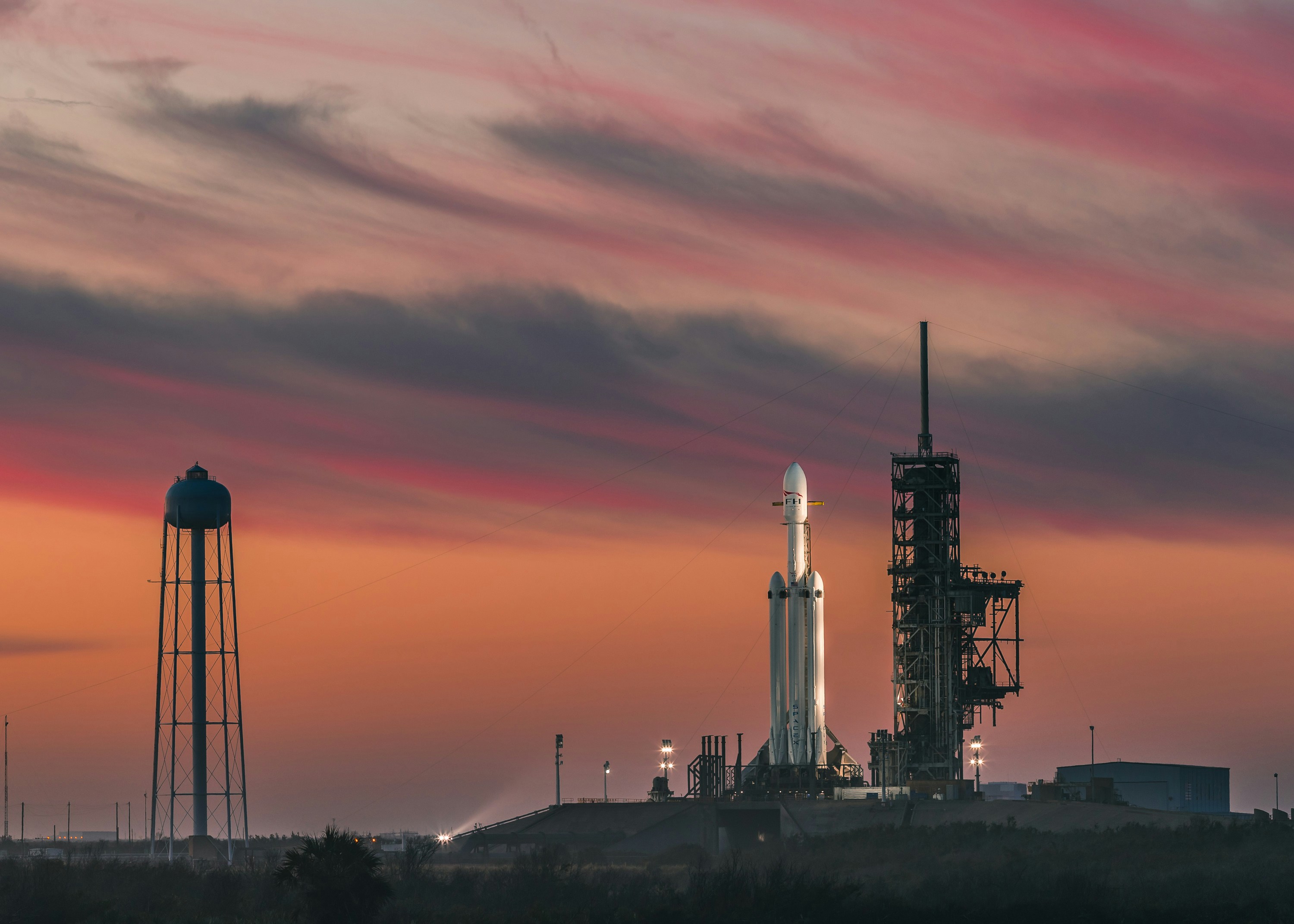 Rocket ascending over the Florida coastline at sunset